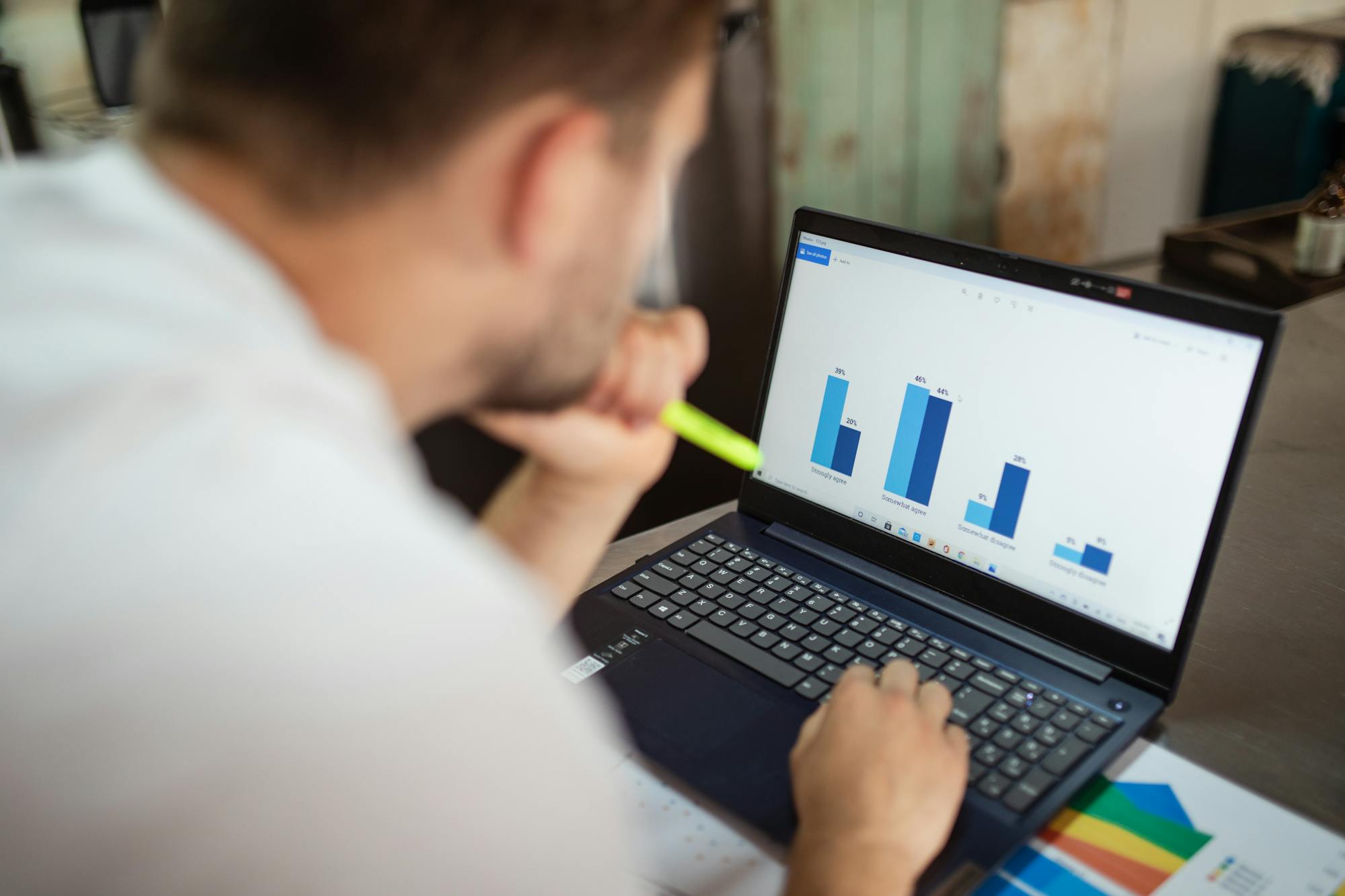 A marketing analyst reviewing chart performance on a laptop